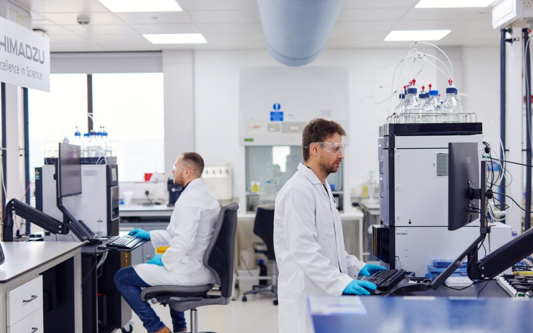 men in lab coats working in laboratory