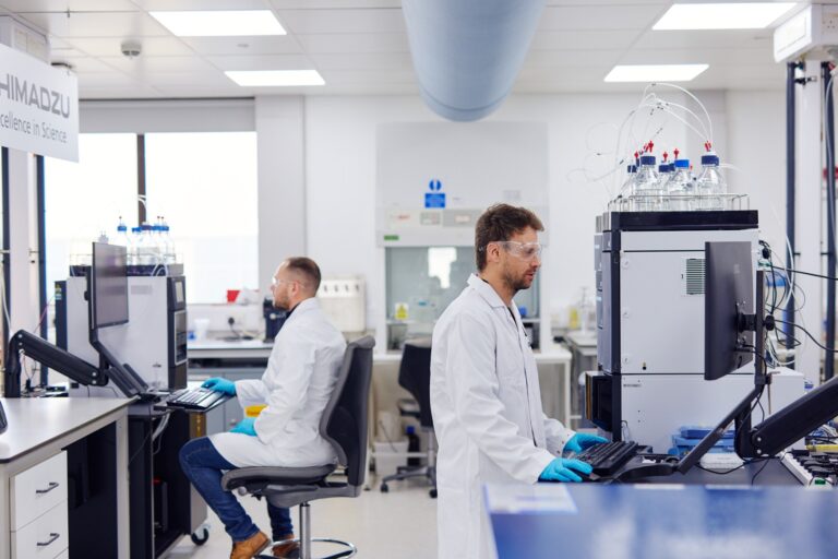 men in lab coats working in laboratory