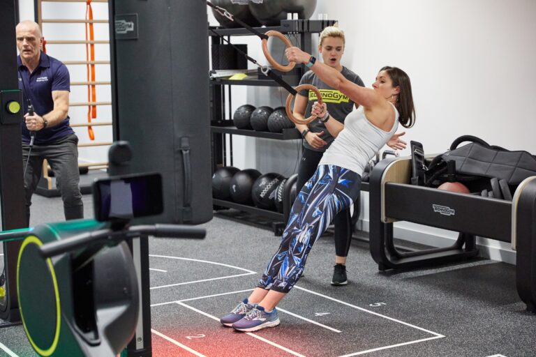 people in an Everybody gym at Alderley Park working on the rig