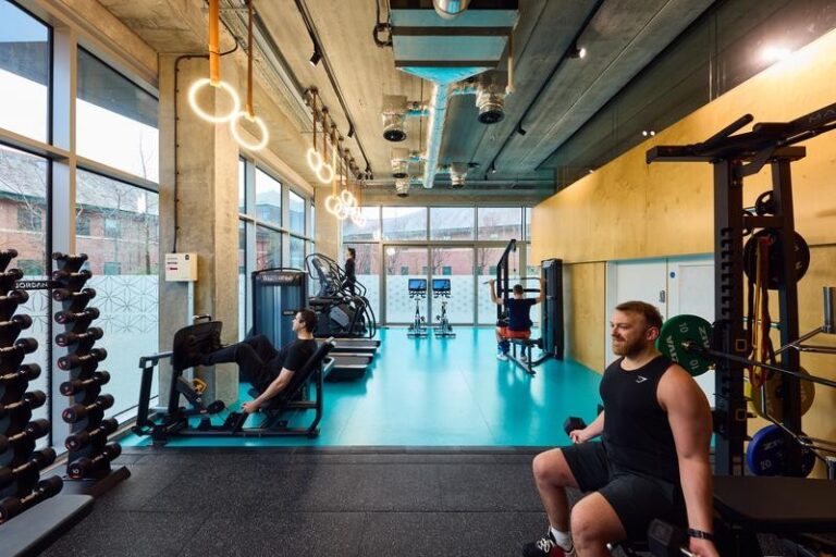 gym space with people working out on different equipment