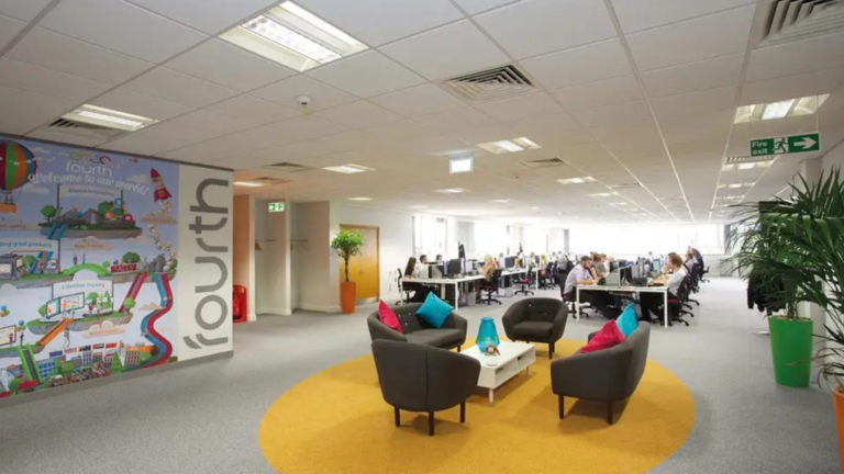 fit out of office space with desks and computers and people sat in chairs