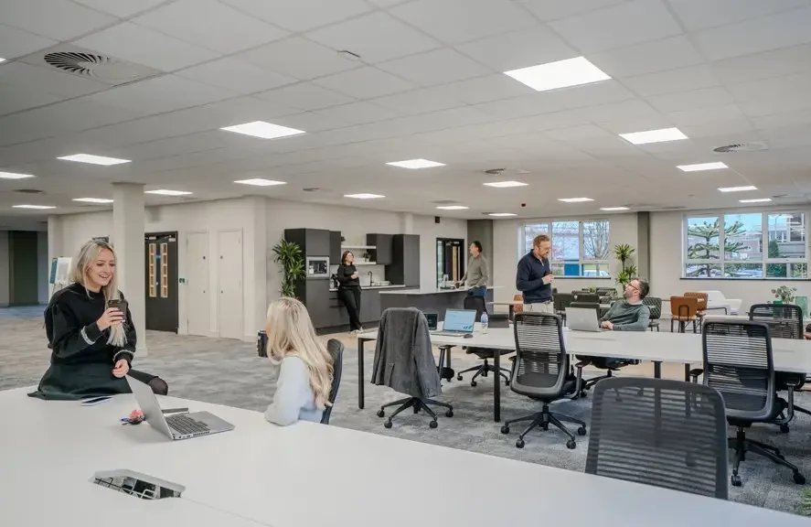 people working and talking in modern open place office space